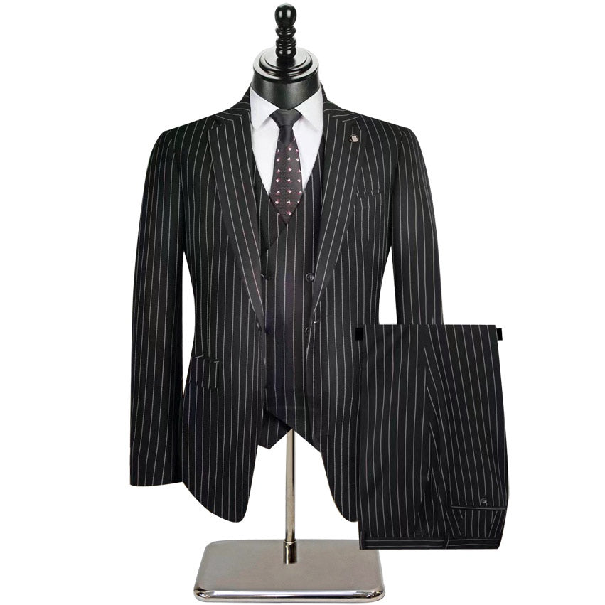 Men's beige pinstripe three-piece suit with a single-breasted jacket, double-breasted vest, and matching trousers, styled