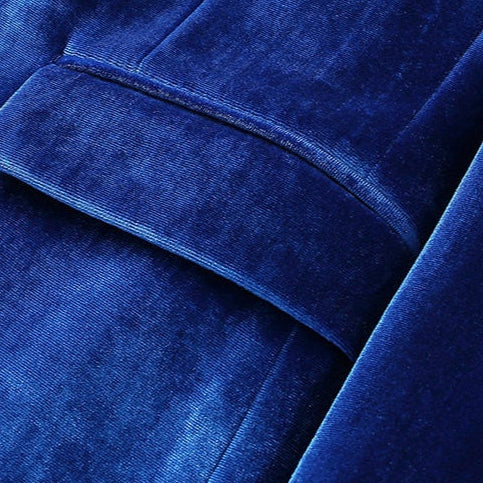 A collection of men's velvet suits in blue, red, gold, purple, and green, each featuring a one-button blazer with a feather