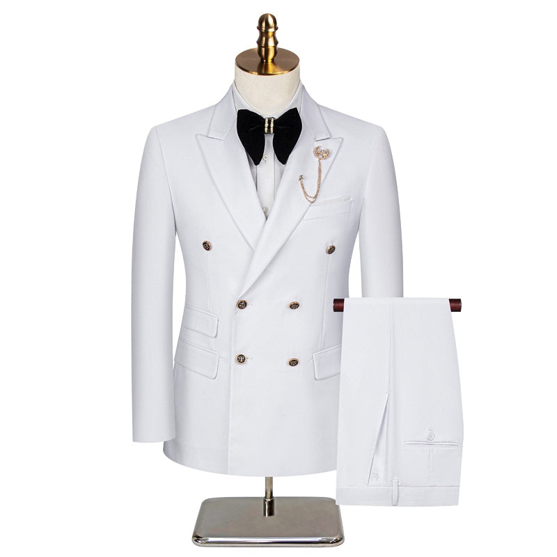 A men's white double-breasted suit with gold buttons, peaked lapels, and a decorative brooch, displayed on a mannequin.