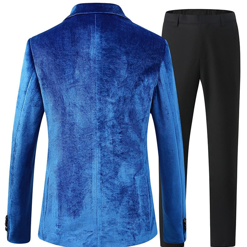 A collection of men's velvet suits in blue, red, gold, purple, and green, each featuring a one-button blazer with a feather