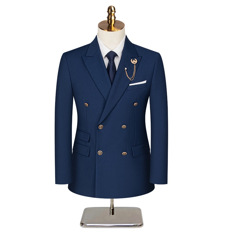 A men's navy blue double-breasted suit with gold buttons, peaked lapels, and a decorative gold chain lapel pin, displayed on