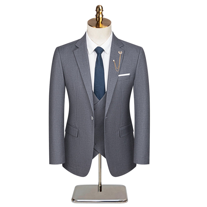 Men's grey three-piece slim fit suit with single-breasted jacket, double-breasted vest, and flat-front trousers, styled with