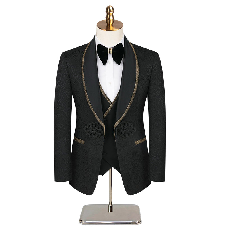 A black men's 3-piece jacquard suit with gold glitter trim on the lapels and vest, displayed on a mannequin.