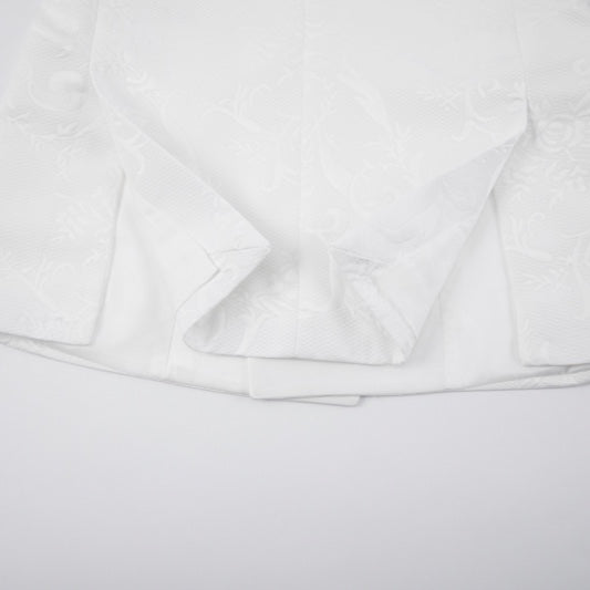 Front view of a men's white double-breasted blazer with gold studded and rhinestone-embellished shawl lapels, featuring a