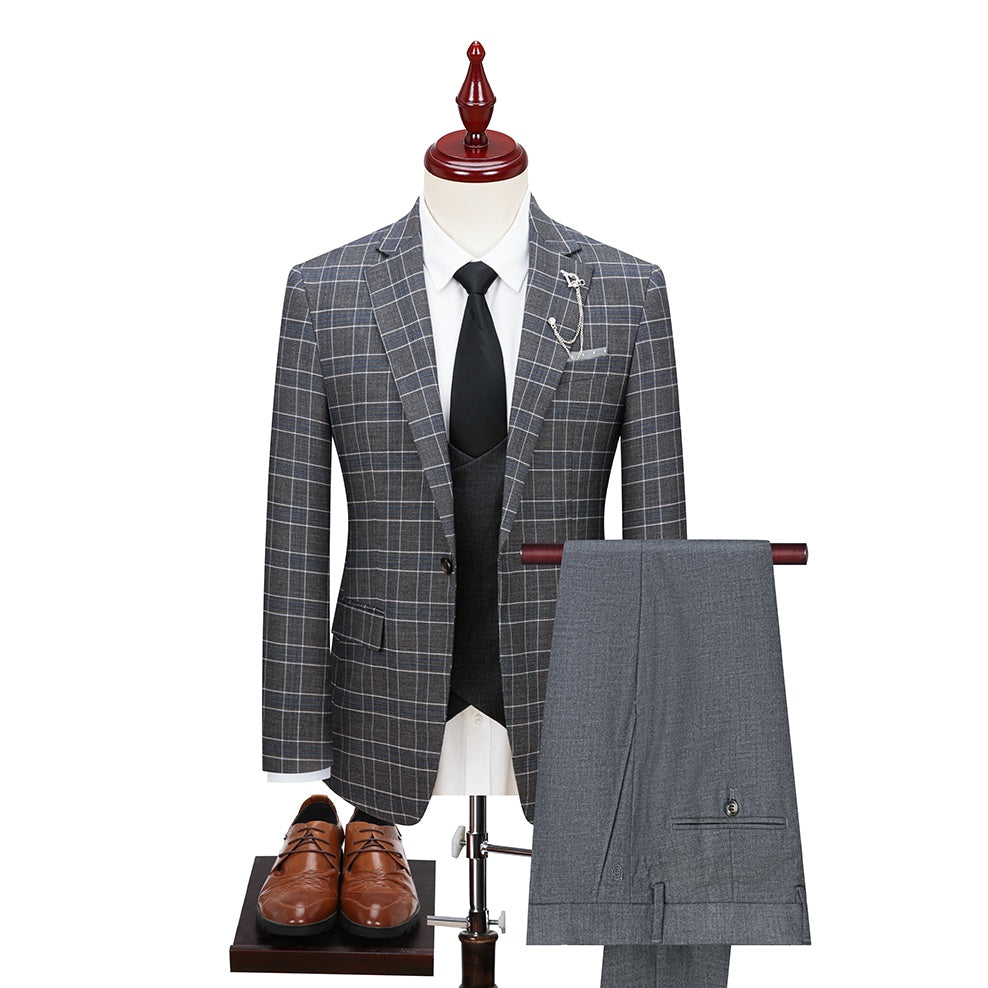 Full view of a men's grey plaid three-piece suit, including a single-button blazer with a lapel pin, a double-breasted vest,