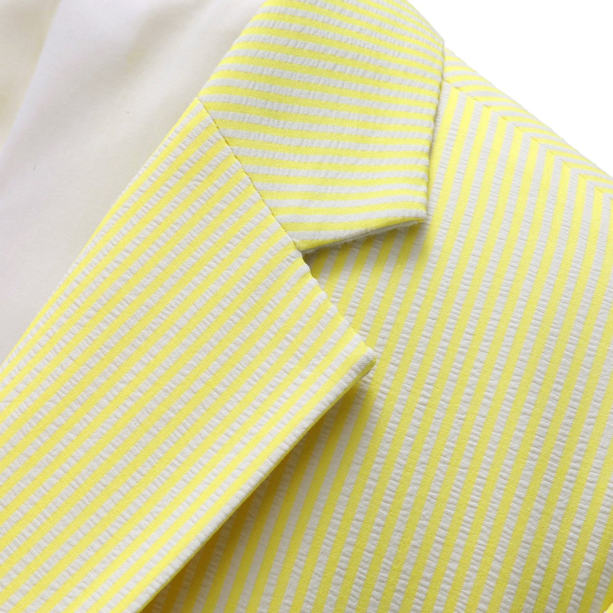 Front view of a men's yellow and white striped seersucker two-piece suit with a single-breasted jacket, notched lapels, and
