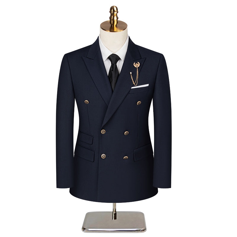 Full view of a men's navy double-breasted suit with gold buttons, a peak lapel, and a decorative brooch, paired with matching