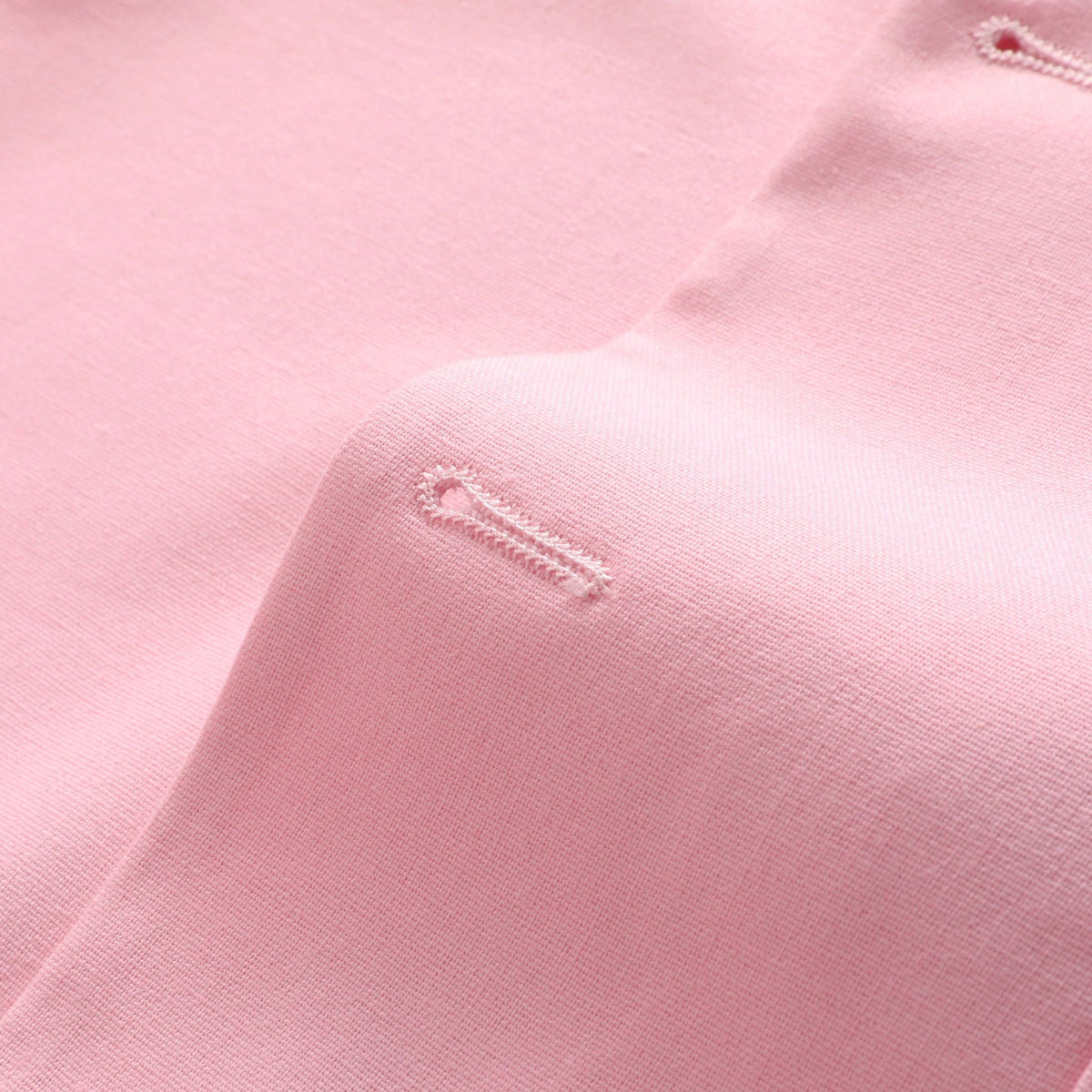 Front view of a men's light pink slim fit suit, featuring a two-button blazer and matching trousers.