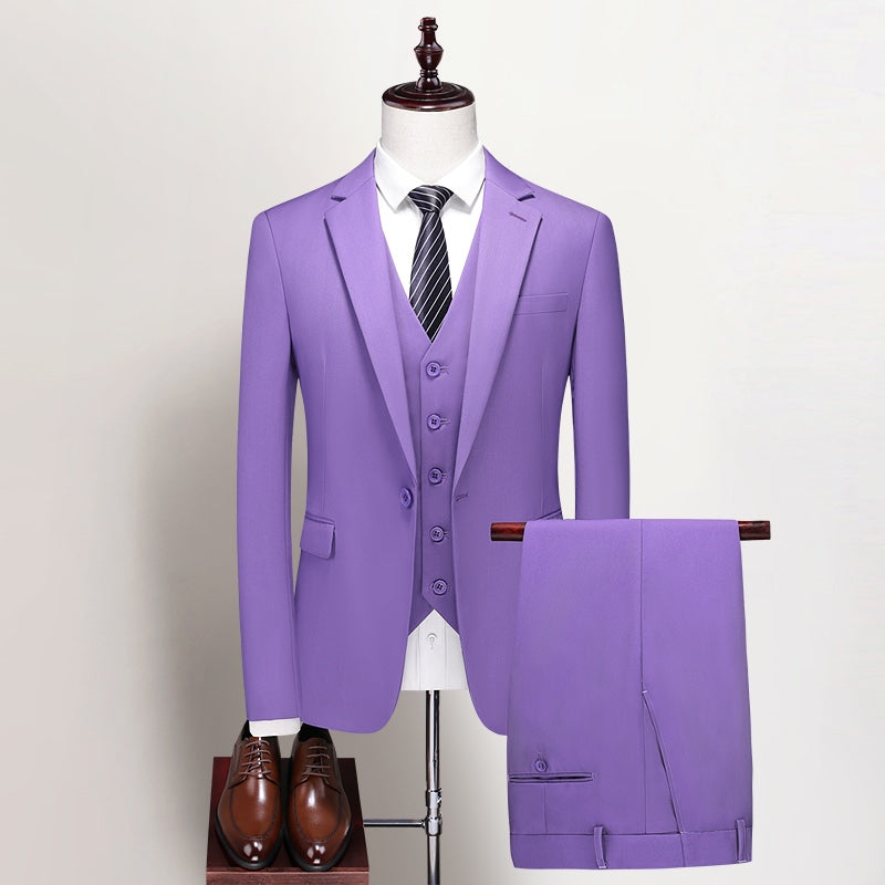 Men's purple three-piece suit, including a blazer, vest, and trousers, displayed on a mannequin with a white shirt and