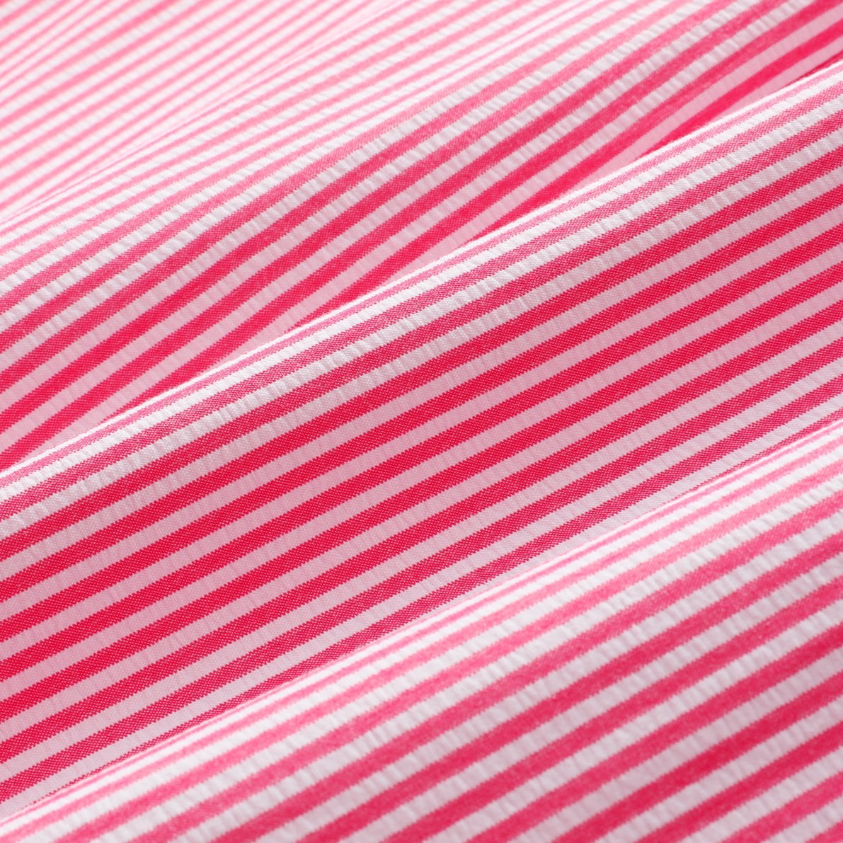 Front view of a men's red and white striped seersucker two-piece suit with a single-button blazer and matching trousers.