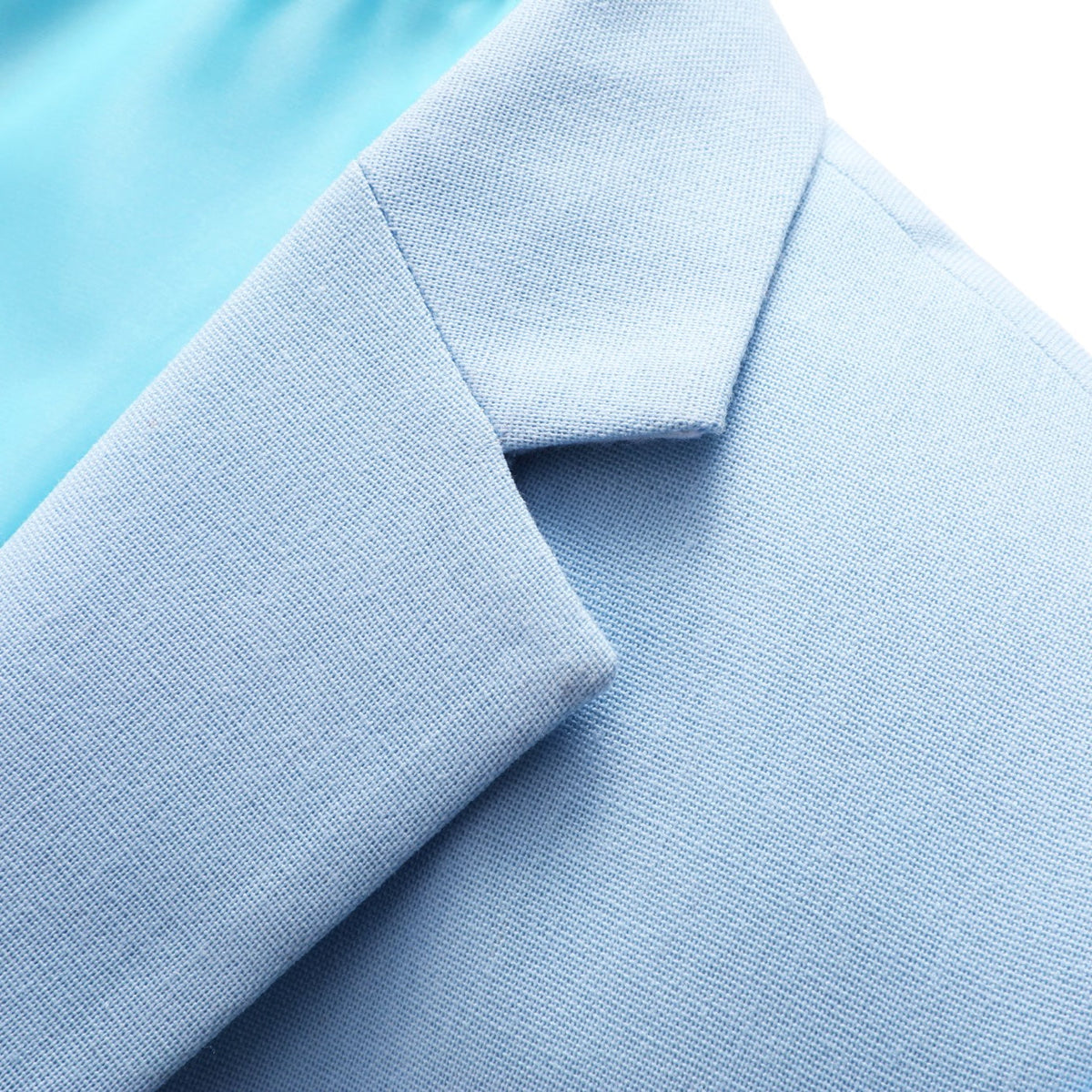 Front view of a men's light blue slim fit two-piece suit with a two-button blazer and matching trousers.