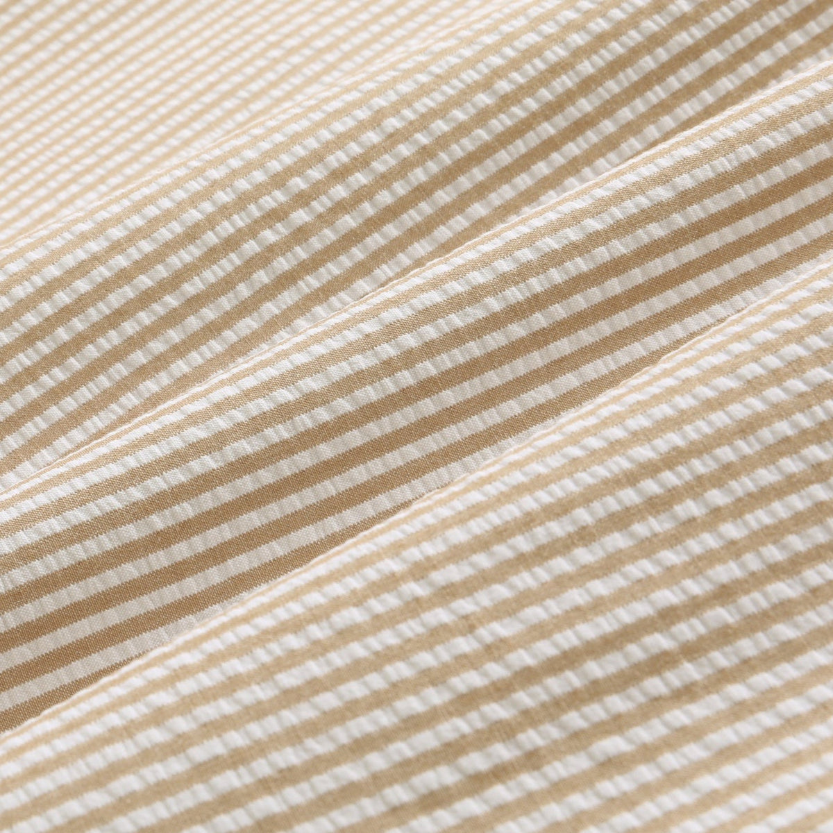 A men's beige and white striped seersucker two-piece suit, including a single-breasted jacket and matching trousers,