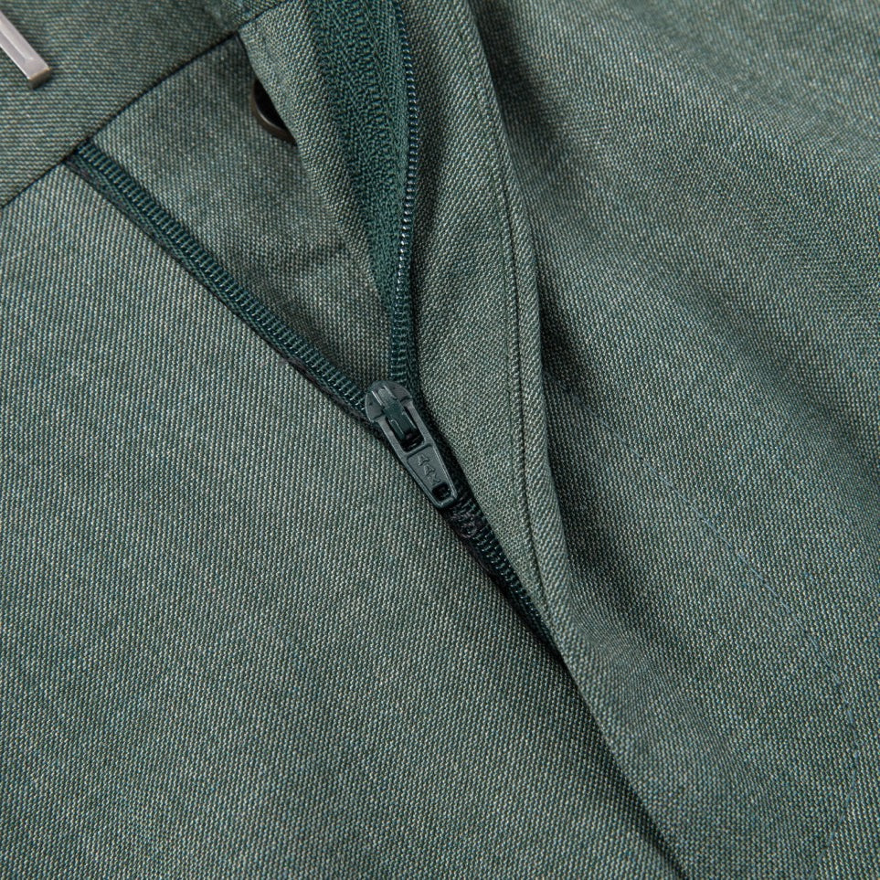 Full view of a men's green textured double-breasted suit with a yellow patterned tie, displayed on a mannequin, with matching